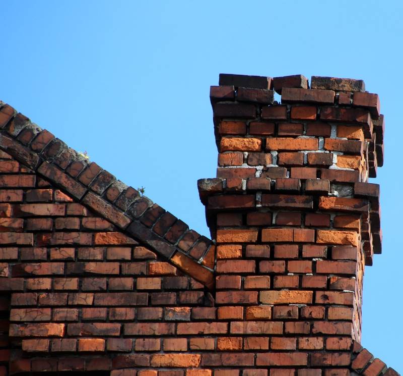 Damaged chimney on an Vista home showing cracks and missing mortar